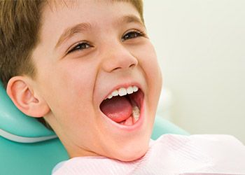 Laughing child in dental chair