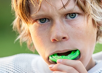 Teen boy placing green sportsguard