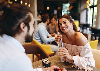 Woman smiling at date in restaurant