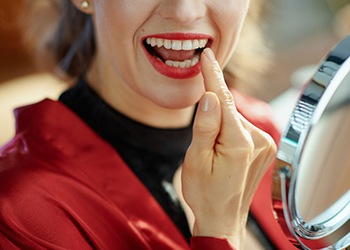 Woman pointing to her tooth