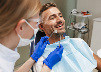 A man having his teeth checked by the dentist