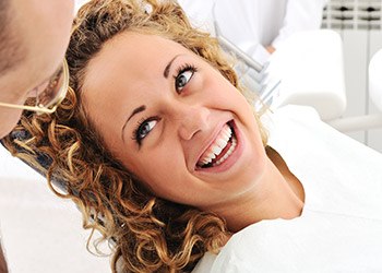 Laughing woman in dental chair