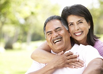 Couple smiling outside