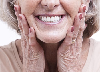 Closeup of older woman’s smile with dental implants in Cumberland