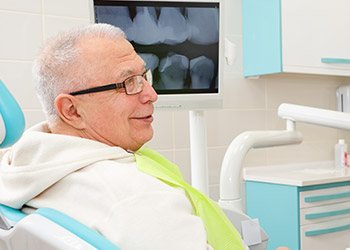 Smiling older man in dental chair