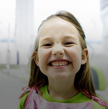 Little girl smiling in dental chair
