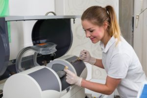 technician using CEREC milling machine