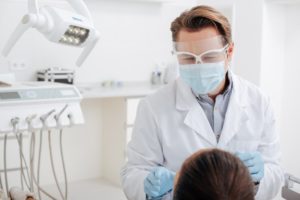 Dentist in Cumberland wearing PPE with patient 