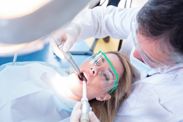 A patient receiving treatment from a dentist.