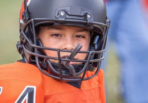 a child wearing a customized mouthguard while playing a sport